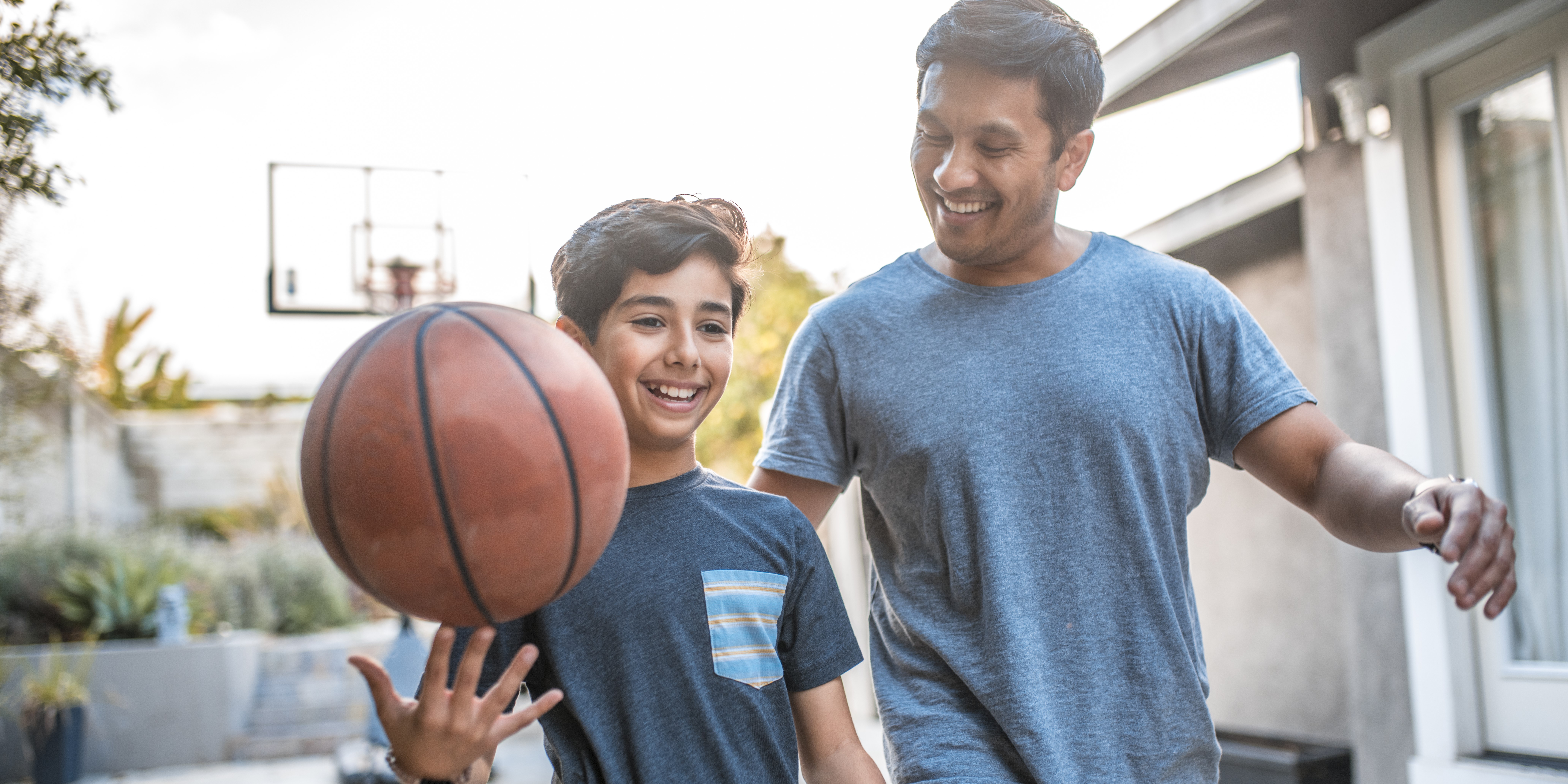 Kid with adult playing basketball